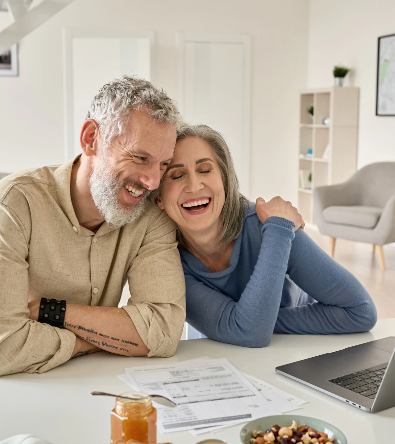 couple going over wealth management plan on laptop