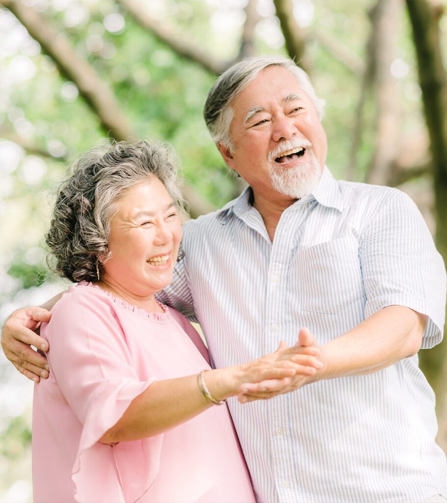 happy senior couple dancing in the park annuity basics beacon financial williston vt 910x1024