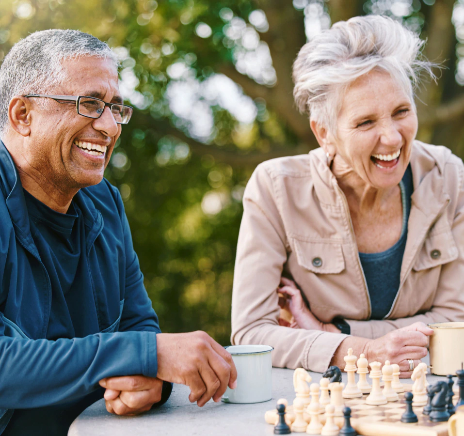 mature adults playing chess and discussing whos who in a fixed indexed annuity