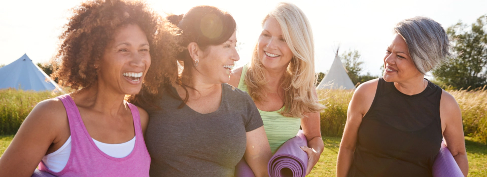 mature women walking to outdoor yoga and discussing what is an iul