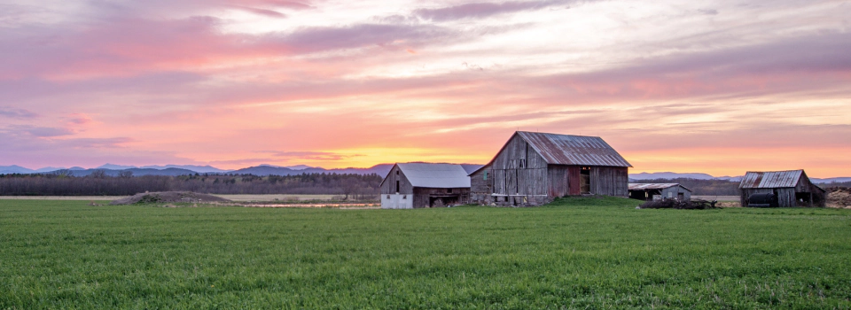 old barn and colorful sky during sunset